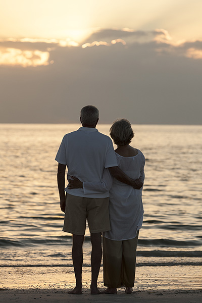 Senior Couple Embracing Sunset Tropical Beach Refer a patient